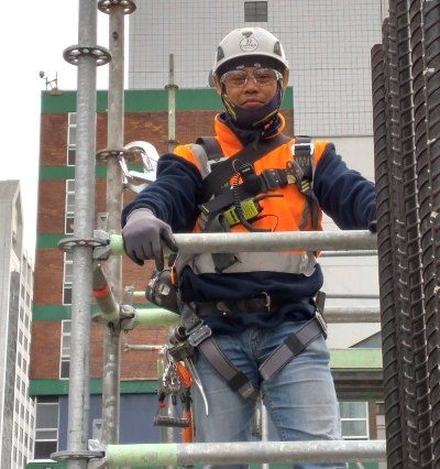 The modern scaffolder in high-vis, steel caps and impact helmet